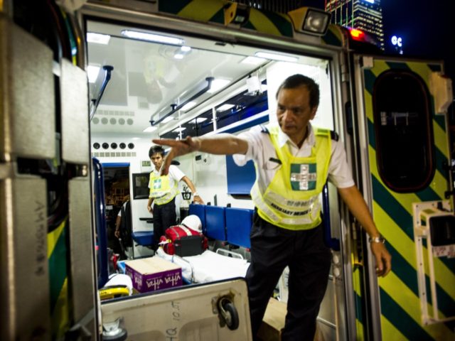 Auxiliary medical staff open the door of an ambulance to show the inside of the vehicle outside the Government Offices building in Hong Kong on October 5, 2014. Pro-democracy demonstrators stood divided over whether to withdraw from protest sites across Hong Kong on October 5, hours before a government deadline …