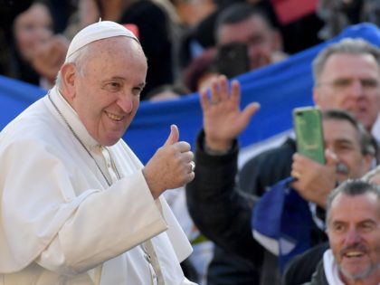 Pope Francis gestures to worshipers as he arrives for the weekly general audience on Novem