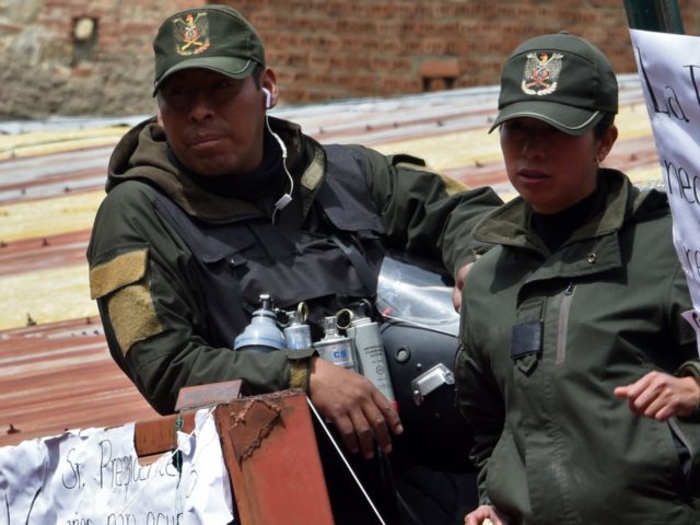 Policemen with a sign against ex-President Evo Morales gather at the police's Special Tact