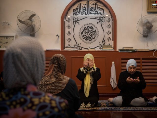 SANGPO, CHINA - JULY 11: Hui Muslim female Imam Yonghua Zheng, center, leads prayers at th