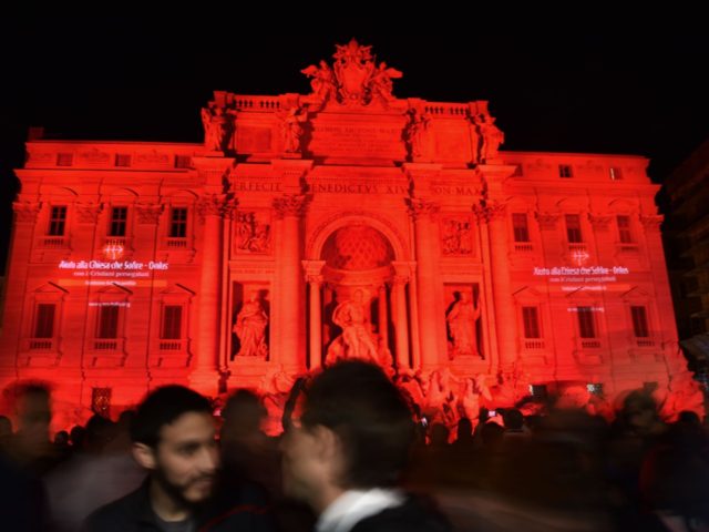 The Trevi fountain is illuminated in red to symbolise blood of persecuted Christians around the world in a grim makeover for one of Italy's most iconic monuments, on April 29, 2016 in Rome. / AFP / GABRIEL BOUYS (Photo credit should read GABRIEL BOUYS/AFP via Getty Images)