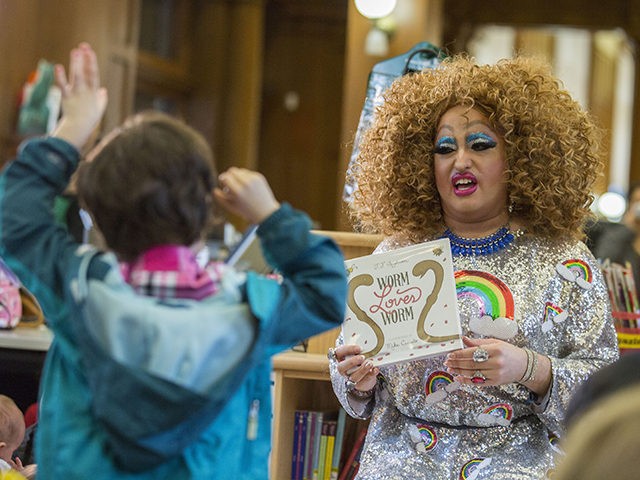 In this Saturday, May 13, 2017 photo, Lil Miss Hot Mess reads to children during the Feminist Press' presentation of Drag Queen Story Hour! at the Park Slope Branch of the Brooklyn Public Library, in New York. (AP Photo/Mary Altaffer)