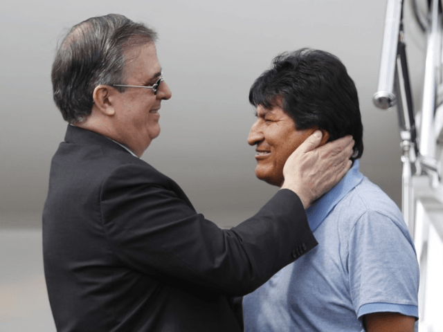 Mexican Foreign Minister Marcelo Ebrard, left, welcomes former Bolivian President Evo Morales upon his arrival in Mexico City on Tuesday. Mexico granted asylum to Morales, who resigned on Nov. 10 under mounting pressure from the military and the public after his reelection triggered weeks of fraud allegations and deadly protests. …