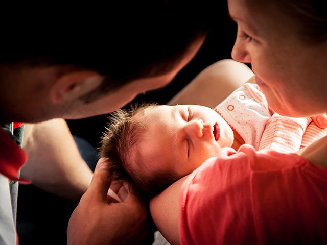 Newborn baby on mother hands - stock photo