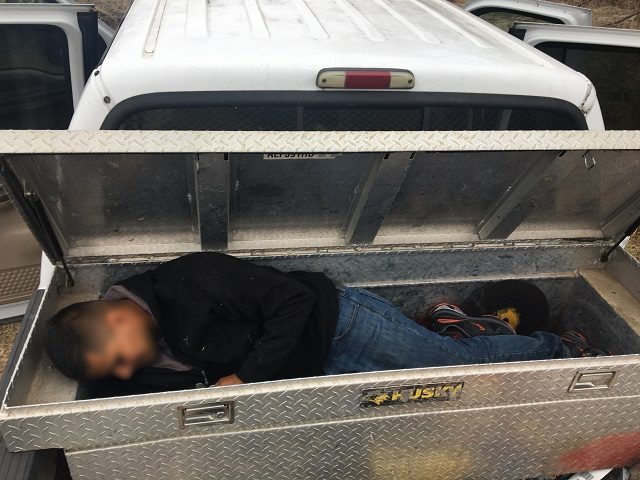 Bordrer Patrol agents find a Mexican migrant locked in a pickup truck's toolbox. (Photo: U