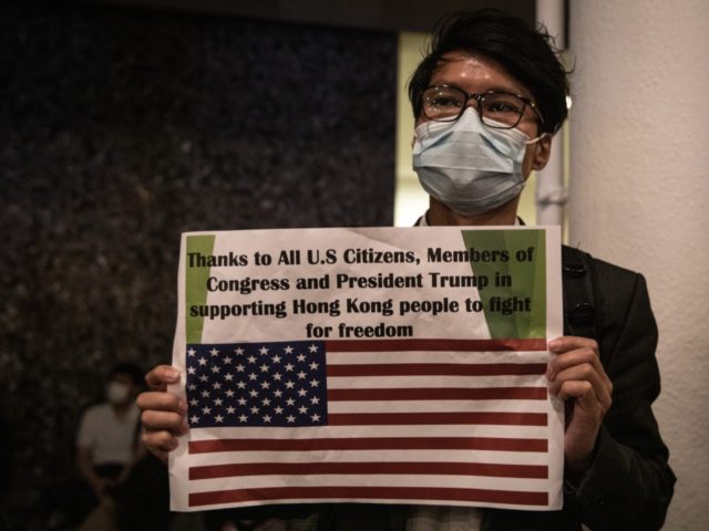 HONG KONG, CHINA - NOVEMBER 28: A pro-democracy protester holds a thank you sign during a Thanksgiving Day rally at Edinburgh Place on November 28, 2019 in Hong Kong, China. Protesters gathered to say thank you to the United States after US President Donald Trump signed legislation supporting the Hong …