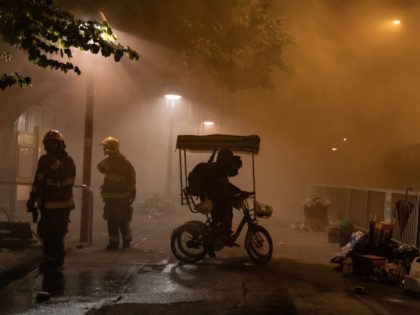 HONG KONG, CHINA - November 13: Pro-democracy protesters ride a four-wheel bike outside of