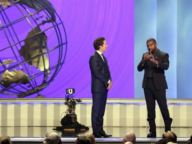 Kanye West, right, answers questions from senior pastor Joel Osteen, left, during a servic