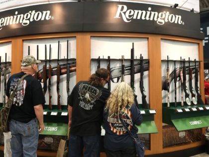 DALLAS, TX - MAY 05: Attendees look at a display of Remington shotguns during the NRA Annu