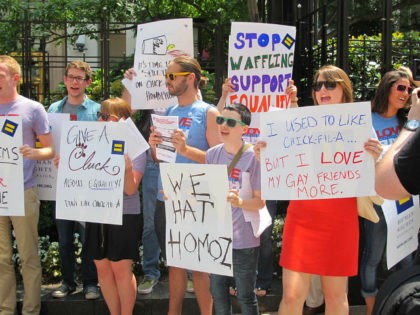 Protesters hold signs and shout slogans outside a Chick-fil-A food truck in a mid-day demonstration organized by the Human Rights Campaign in Washington on 26 July, 2012 after the fast-food firm's president Dan Cathy came out against marriage equality in the United States. The protesters accused Chick-fil-A of a long …