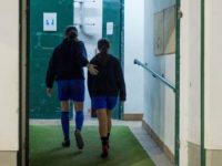 Two girls walk into de locker room after attending a training session at the Anorga KKE football school in the Spanish Basque city of San Sebastian on February 18, 2019. (Photo by ANDER GILLENEA / AFP) (Photo credit should read ANDER GILLENEA/AFP via Getty Images)