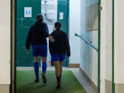 Two girls walk into de locker room after attending a training session at the Anorga KKE football school in the Spanish Basque city of San Sebastian on February 18, 2019. (Photo by ANDER GILLENEA / AFP) (Photo credit should read ANDER GILLENEA/AFP via Getty Images)