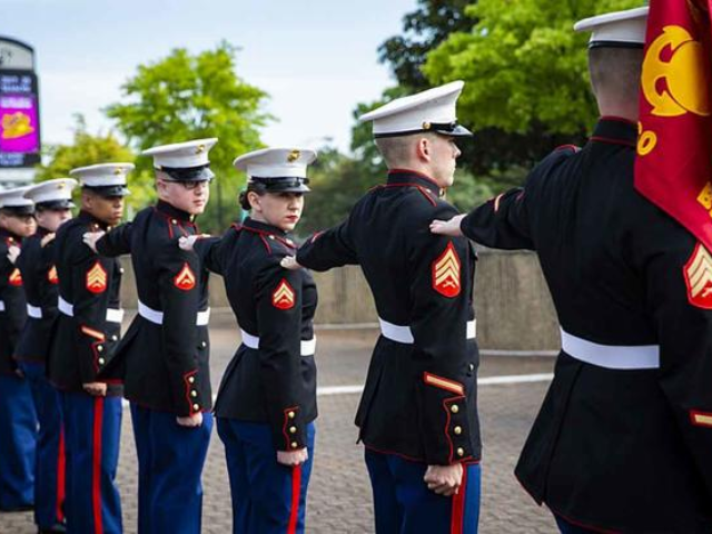 Members of the Marine Corps Band have their Dress Blue Alpha uniforms inspected during the