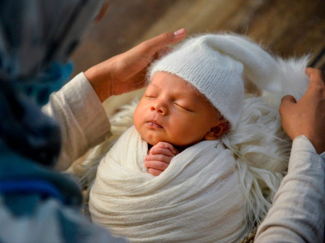 Fanny Nurdiana, a female photographer, works during a photo session of a newborn baby in B