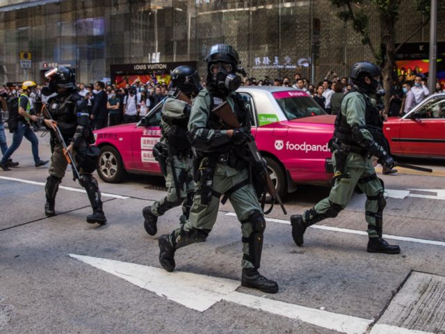 Riot police secure a road in the Central district of Hong Kong on November 11, 2019. - A p