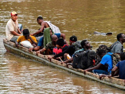 Haitian migrants cross the Chucunaque River by boat to the Temporary Station of Humanitarian Assistance (ETAH) in La Penita village, Darien province, Panama on May 23, 2019. - Migrants mainly from Haiti, Cuba, Democratic Republic of Congo, India, Cameroon, Bangladesh and Angola cross the border between Colombia and Panama through …