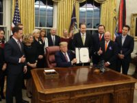 WASHINGTON, DC - NOVEMBER 25: U.S. President Donald Trump poses with animal rights supporters after signing H.R. 724, the Preventing Animal Cruelty and Torture Act, in the Oval Office at the White House on November 25, 2019 in Washington, DC. (Photo by Mark Wilson/Getty Images)