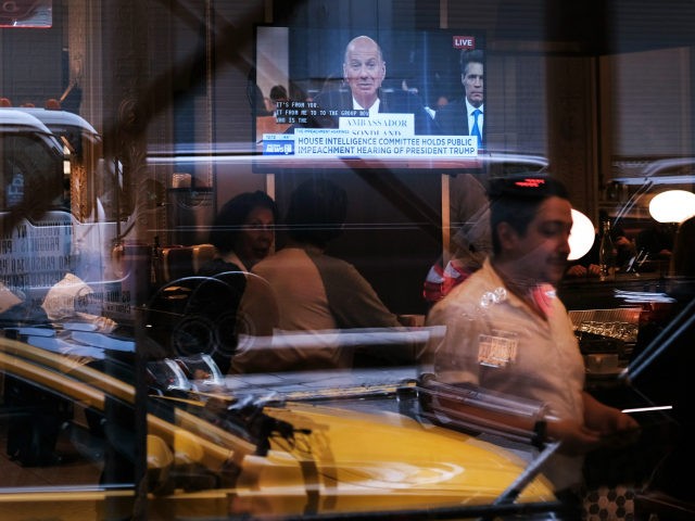A television in a restaurant shows Ambassador to the European Union Gordon Sondland as he