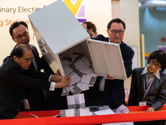 HONG KONG, CHINA - NOVEMBER 24: Barnabus Fung (2nd R) and Patrick Nip Tak-kuen (2nd L) empty a ballot box to count votes at a polling station on November 24, 2019 in Hong Kong, China. Hong Kong held its district council election on Sunday as anti-government protests continue into a …