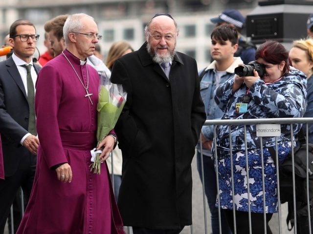 Archbishop of Canterbury Justin Welby (2nd R) and Chief Rabbi Ephraim Mirvis (R) join other faith leaders for a vigil for the victims of the London Bridge terror attacks, in Potters Fields Park on June 5, 2017 in London, England. Seven people were killed and at least 48 injured in …