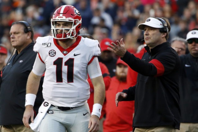 Georgia Auburn Football Georgia quarterback Jake Fromm (11) talks with head coach Kirby Smart during the first half of an NCAA college football game, Saturday, Nov. 16, 2019, in Auburn, Ala. (AP Photo/Butch Dill) The Associated Press