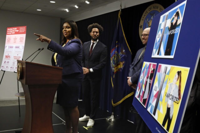 Juul New York Lawsuit Letitia James, Andre Richardson, Adam FIne New York State Attorney General Letitia James speaks during a news conference at her office in New York, Tuesday, Nov. 19, 2019. New York has joined the ranks of states suing the nation's biggest e cigarette maker, San Francisco based JUUL Labs. At background left and right are Andre Richardson, campaign manager of Flavors Hook Kids, and East Hampton High School Principal Adam Fine. (AP Photo/Richard Drew) The Associated Press