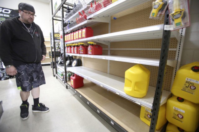 California Wildfires Utility Grass Valley's Dionicio Torres looks at the gas can selection before taking the last 5 gallon gas can on the shelves at B&C Ace Home & Garden Center, in Grass Valley, Calif., Tuesday, Nov. 19, 2019, in preparation of Wednesday's planned public safety power shutdown. (Elias Funez/The Union via AP) The Associated Press