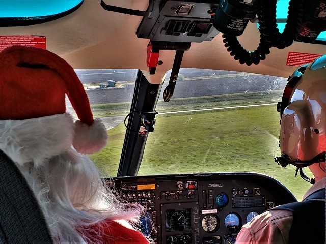 CBP Air and Marine Operations fly Santa Clause to bring gifts to children near the Texas b