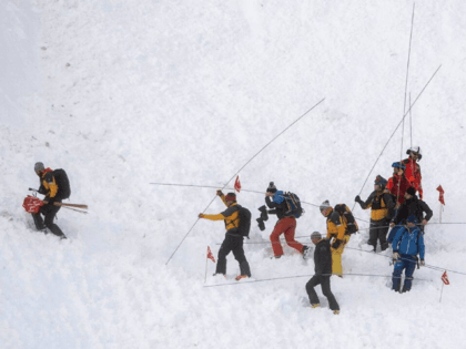 Rescue forces search for missing people after an avalanche swept down a ski piste in the central town of Andermatt, canton Uri, Switzerland, Thursday, Dec. 26, 2019. The avalanche occurred mid-morning Thursday while many holiday skiers enjoyed mountain sunshine the day after Christmas. (Keystone via AP)