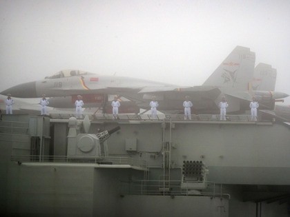 FILE - In this April 23, 2019, file photo, sailors stand near fighter jets on the deck of the Chinese People's Liberation Army (PLA) Navy aircraft carrier Liaoning as it participates in a naval parade in the sea near Qingdao in eastern China's Shandong province. China says its first entirely …