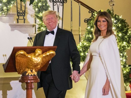 President Donald Trump with first lady Melania Trump walk from the residence to speak in the Grand Foyer of the White House during the Congressional Ball, Thursday, Dec. 12, 2019, in Washington. (AP Photo/Manuel Balce Ceneta)