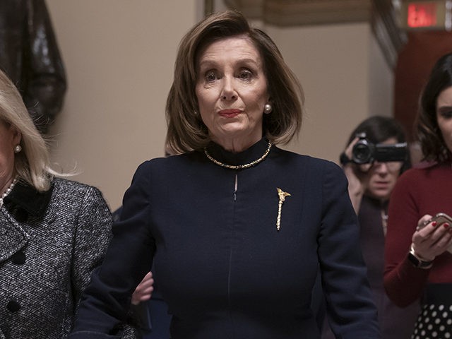 Speaker of the House Nancy Pelosi, D-Calif., holds hands with Rep. Debbie Dingell, D-Mich., as they walk to the chamber where the Democratic-controlled House of Representatives begins a day of debate on the impeachments charges against President Donald Trump for abuse of power and obstruction of Congress, at the Capitol …