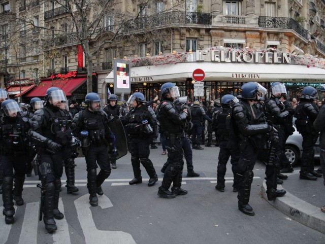 Riot police officers take position outside the the Gare de Lyon train station during a dem