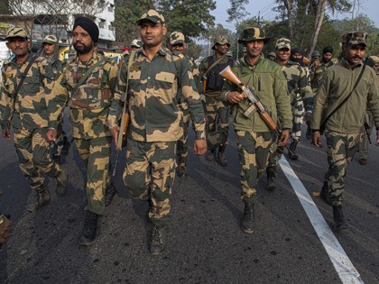 Indian paramilitary soldiers walk behind students participating in a protest against the Citizenship Amendment Act in Gauhati, India, Tuesday, Dec. 24, 2019. Tens of thousands of protesters have taken to India’s streets to call for the revocation of the law, which critics say is the latest effort by Narendra Modi’s …