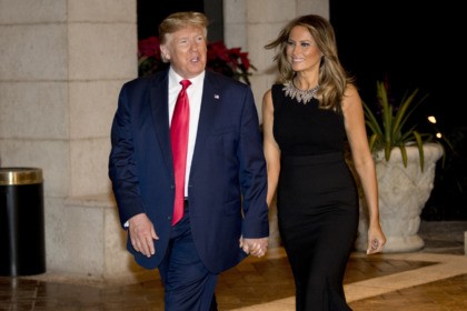 President Donald Trump and first lady Melania Trump arrive for Christmas Eve dinner at Mar-a-lago in Palm Beach, Fla., Tuesday, Dec. 24, 2019. (AP Photo/Andrew Harnik)