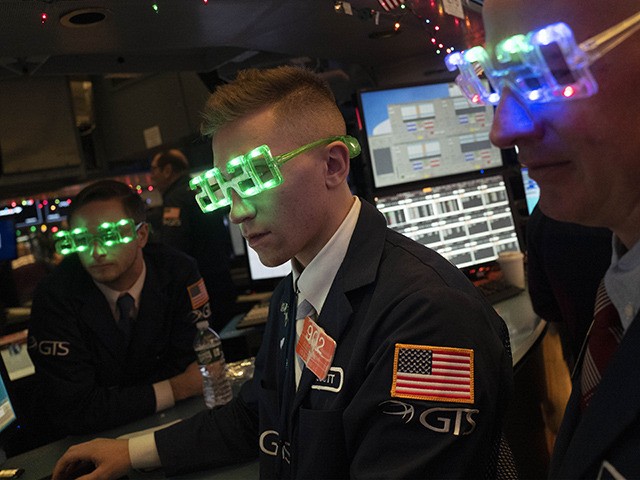 Stock traders wear New Year's 2020 party glasses at New York Stock Exchange, Tuesday, Dec.