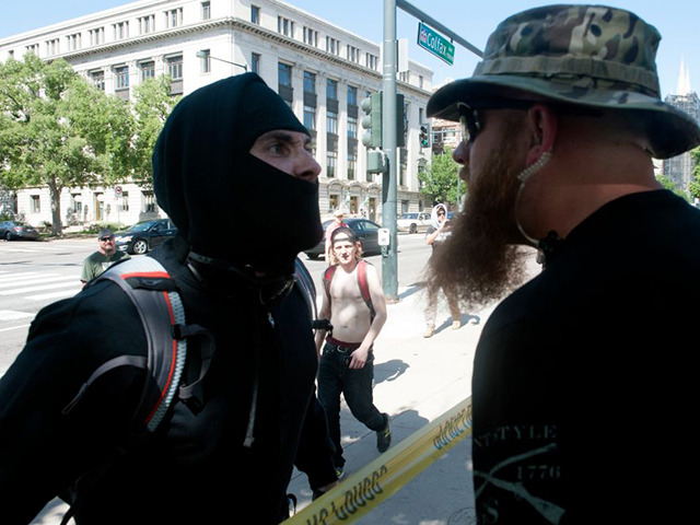 An Antifa demonstrator has a heated exchange with a pro-Trump supporter during the Denver March Against Sharia Law in Denver, Colorado on June 10, 2017.