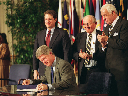 WASHINGTON, : U.S. President Bill Clinton signs the North American Free Trade Agreement (NAFTA) 08 December 1993 as (from left) Vice President Al Gore, House Minority Leader Bob Michel and Speaker of the House Tom Foley watch. The controversial pact will phase out tariffs between the U.S., Mexico, and Canada. …
