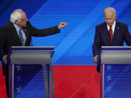 Sen. Bernie Sanders, I-Vt., left, speaks as former Vice President Joe Biden, right, listen