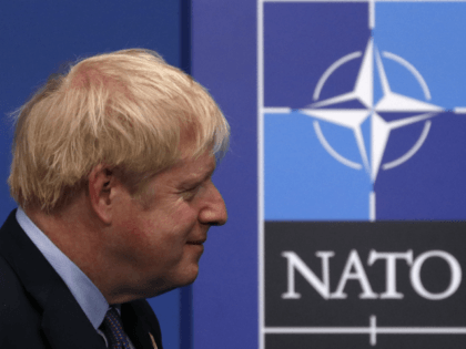 Britain's Prime Minister Boris Johnson waits for arrivals at the NATO summit at the Grove hotel in Watford, northeast of London on December 4, 2019. (Photo by Adrian DENNIS / AFP) (Photo by ADRIAN DENNIS/AFP via Getty Images)