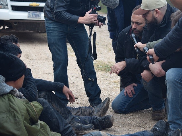 Breitbart Border/Cartel Chronicles projects Director Brandon Darby asks migrants why they cross through this section of the border. (Photo: Bob Price/Breitbart Texas)