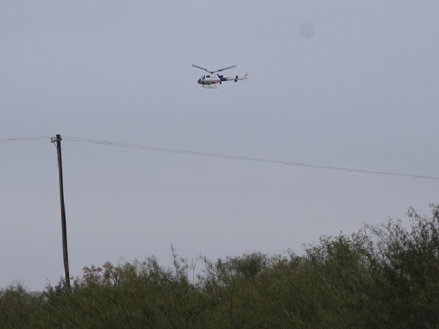 A CBP Air and Marine Operations aircrew provides air cover as Border Patrol agents work to find a group of migrants who just crossed the Rio Grande. (Photo: Bob Price/Breitbart Texas)