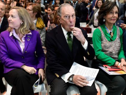 Democratic presidential hopeful Michael Bloomberg (C) sits between Spanish Santander Bank executive chairperson Ana Botin (R) and Spanish careteker minister for economic affairs Nadia Calvino as they attend an event within the UN Climate Change Conference COP25 at the 'IFEMA - Feria de Madrid' exhibition centre, in Madrid, on December …
