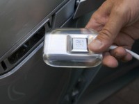 Bob Boniface, design director of the Chevrolet Volt, an electric vehicle concept car, demonstrates how the car can be recharged using standard household electricity during a public viewing at Washington Harbour in Washington, DC, 20 July 2007. Chevrolet expects a production version of the car, which uses no gasoline, produces …