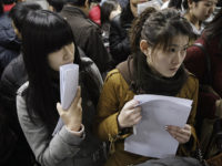 Two job seekers wait to apply for vacancies at a job fair for college graduates in Beijing, China, Tuesday, Feb. 17, 2009. The once ravenous international appetite for Chinese-made goods is shrinking, leading to increased unemployment in the country. Though official unemployment figures often understate the reality, the government has …
