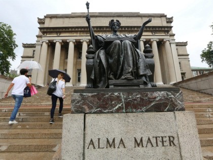 People walk past the Alma Mater statue on the Columbia University campus on July 1, 2013 i