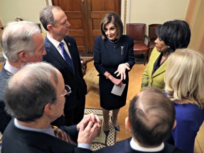 WASHINGTON, DC - DECEMBER 18: Speaker of the House Nancy Pelosi (D-CA) speaks with House Intelligence Committee Rep. Adam Schiff (D-CA) (L) and Chairwoman of House Financial Services Committee Rep. Maxine Waters (D-CA) (R) along with other Representatives in the Speaker's ceremonial office after the second article of impeachment of …
