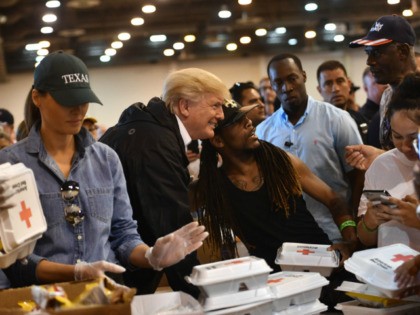 US President Donald Trump and First Lady Melania Trump serve food to Hurricane Harvey victims at NRG Center in Houston on September 2, 2017. / AFP PHOTO / Nicholas Kamm (Photo credit should read NICHOLAS KAMM/AFP via Getty Images)