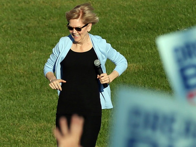 Democratic presidential candidate Elizabeth Warren, D-Mass., runs to the platform as she a