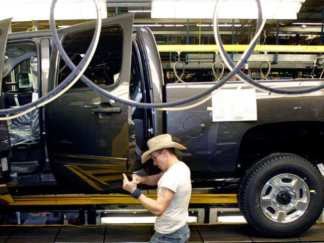 FLINT, MI - JANUARY 24: A person in a cowboy hat works on building a Chevy pickup truck on the assembly line of the General Motors Flint Assembly Plant January 24, 2011 in Flint, Michigan. In response to customer demand GM announced they are adding a third shift and an …